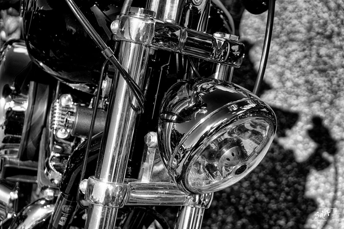 Motorradscheinwerfer einer Harley Davidson, fotografiert von Danny Koerber in Schwarz Weiß.
